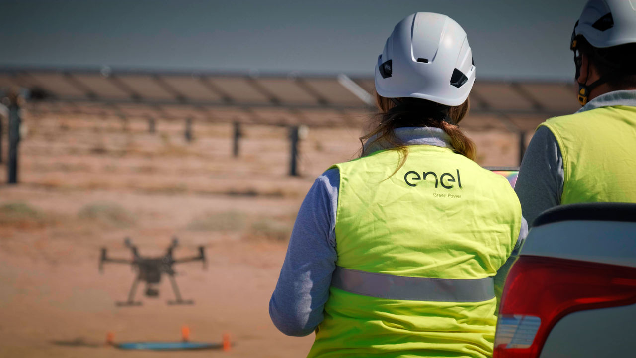Woman wearing an Enel Green Power vest in a solar energy plant 